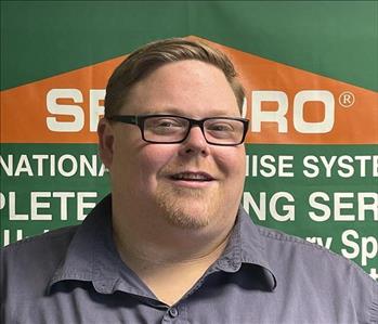 Man standing in front of a Servpro sign