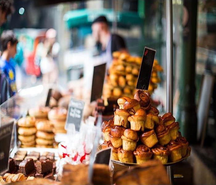 Freshly baked cakes and pastries in a row at food market