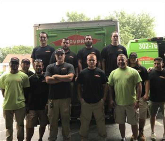 Work crew in front of SERVPRO truck