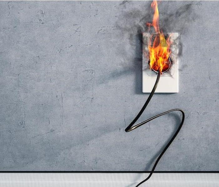 fire and smoke on electric wire plug indoors